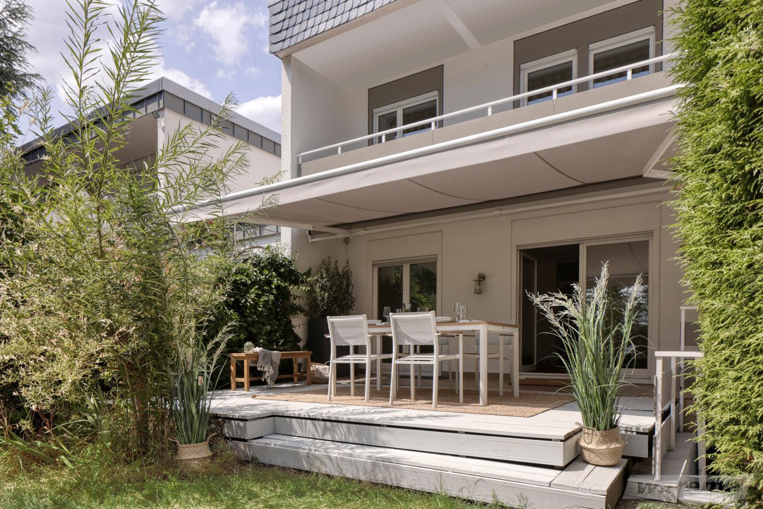 Ausgefahrene Sonnenmarkise G60 von Warema auf einem Vorsprung mit Gartenmöbeln